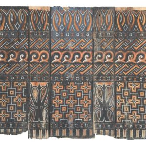 An authentic antique hand-carved wooden side panel from a Toraja Alang (lumbung or rice barn), decorated with traditional geometric Pa'ssura motifs in black, red, and ochre.